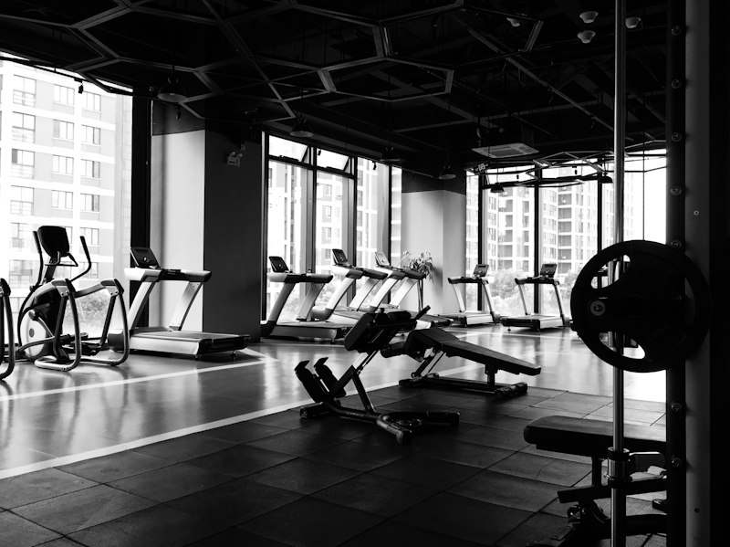 Athlete stretching dark gym